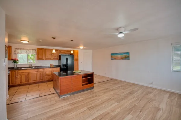 a living room with kitchen furniture and a wooden floor