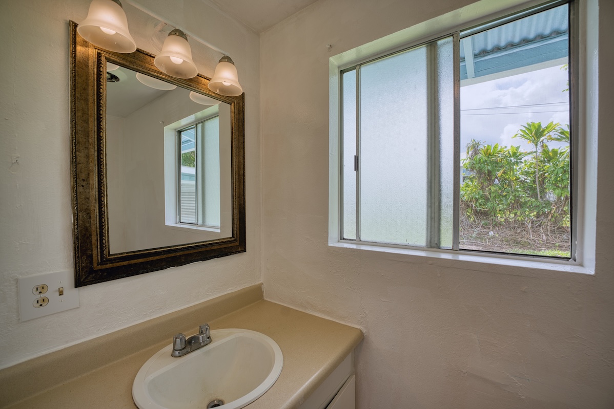 2059 Kinoole Street Hilo, HI 96720 - Photo 16 of 30 a bathroom with a sink and a mirror