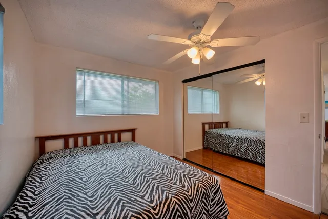 a bedroom with a bed and wooden floor