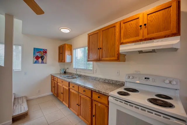 a kitchen with stainless steel appliances granite countertop a sink and a stove