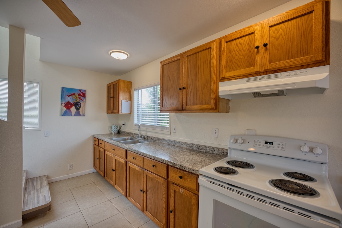 2059 Kinoole Street Hilo, HI 96720 - Photo 2 of 30 a kitchen with stainless steel appliances granite countertop a sink and a stove