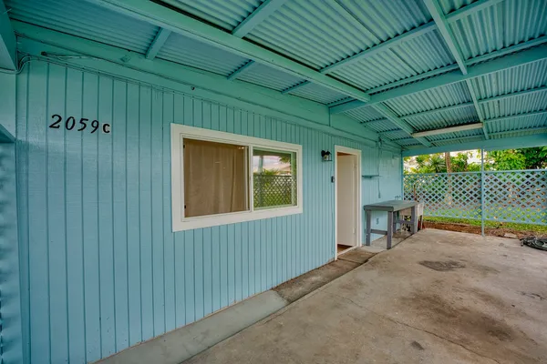 a view of a backyard with wooden fence