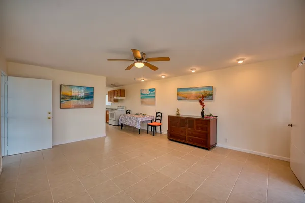 a view of a livingroom with furniture and a ceiling fan