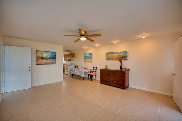 a view of a livingroom with furniture and a ceiling fan