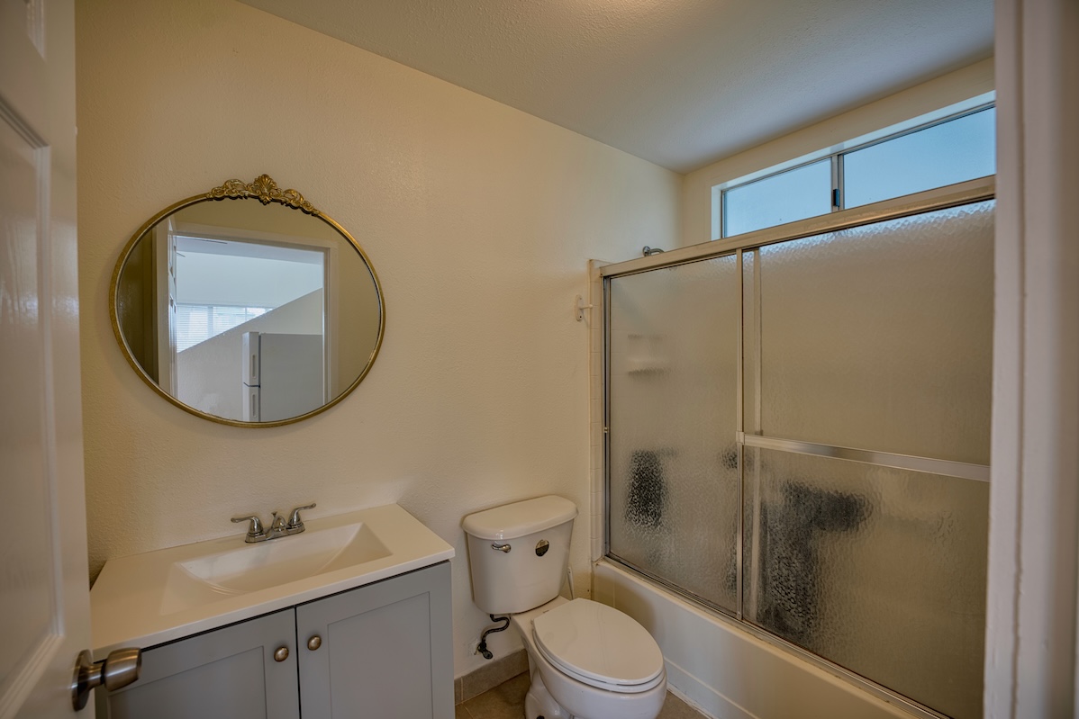 2059 Kinoole Street Hilo, HI 96720 - Photo 9 of 30 a bathroom with a toilet a sink and a mirror