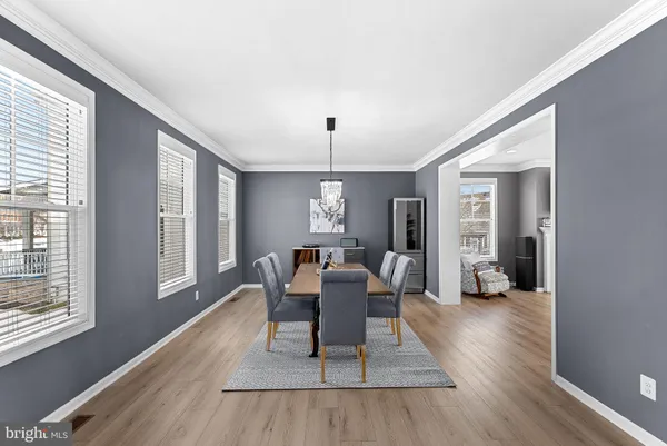 a view of a dining room with furniture wooden floor and chandelier