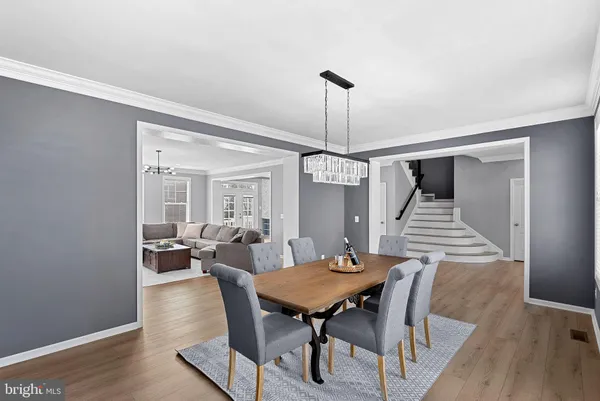 a view of a workspace with furniture and wooden floor