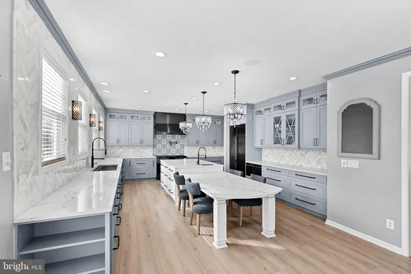 a kitchen with granite countertop a sink stainless steel appliances and cabinets
