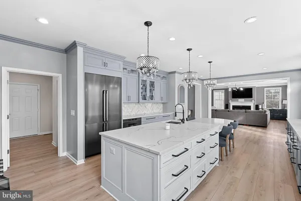 a spacious bedroom with a bed and lamp