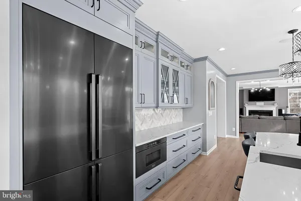 a bathroom with a bathtub shower sink vanity and mirror
