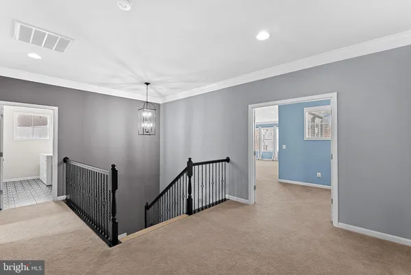 a living room with furniture and a ceiling fan