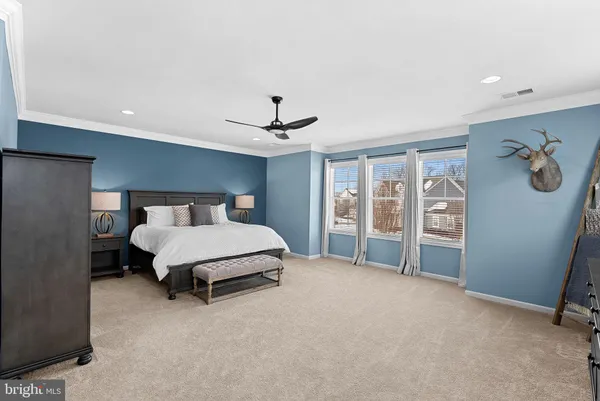 a bedroom with a bed and a mirror