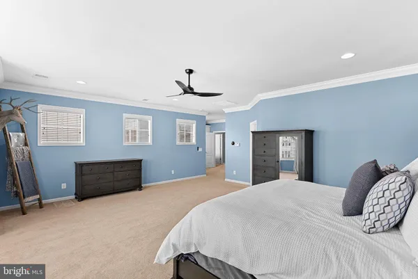a bedroom with a bed wooden floor and window