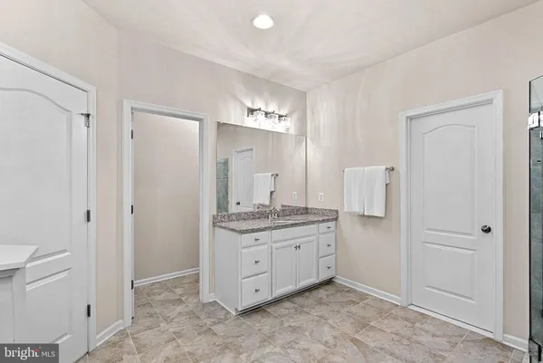 a spacious bedroom with a bed and a window