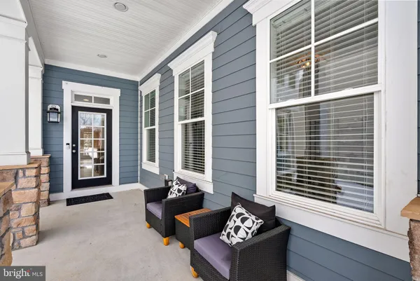 a front view of a house with outdoor seating