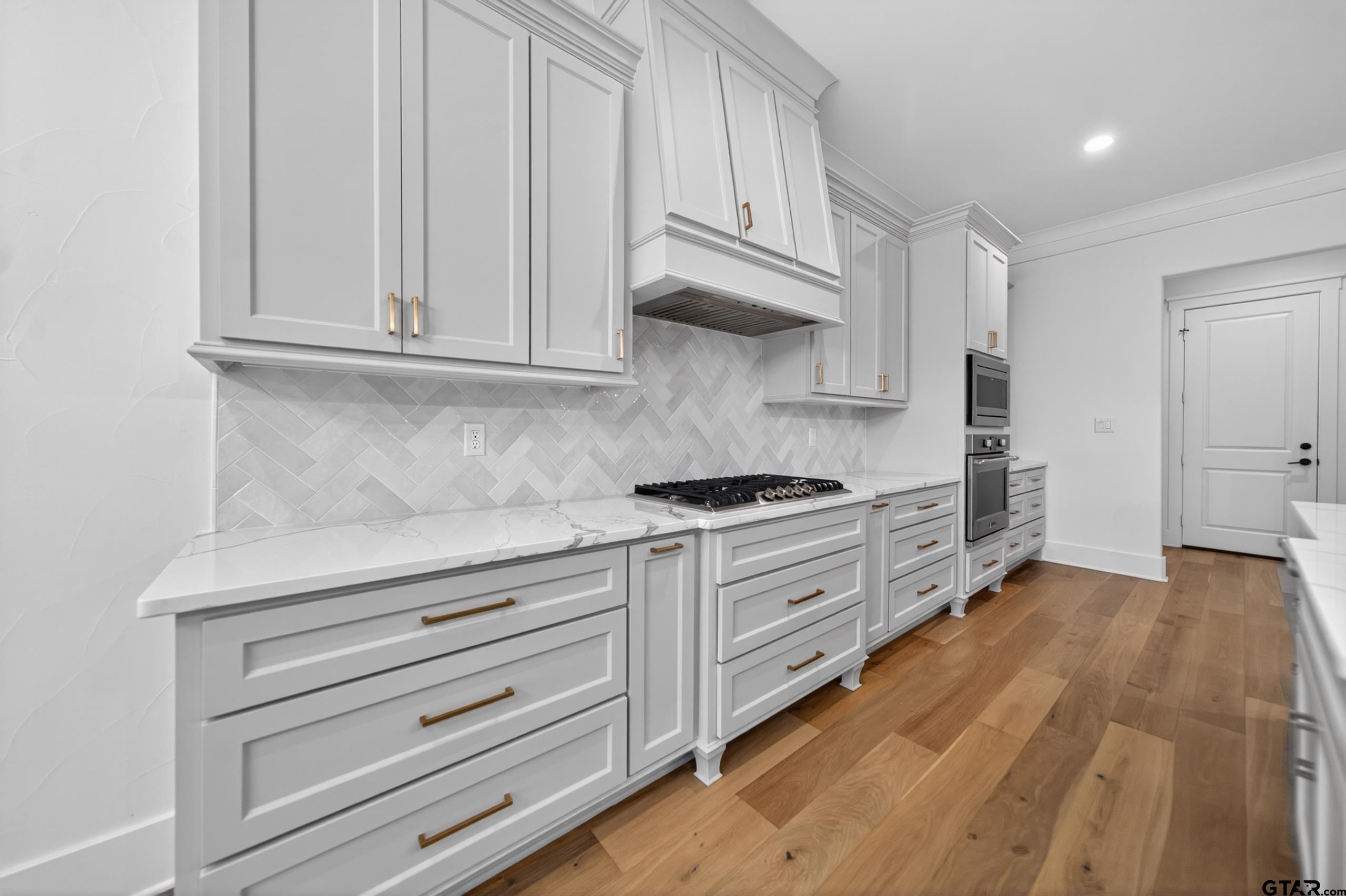 7517 Cross Gate Way Tyler, TX 75703 - Photo 5 of 47 a kitchen with granite countertop white cabinets and stainless steel appliances
