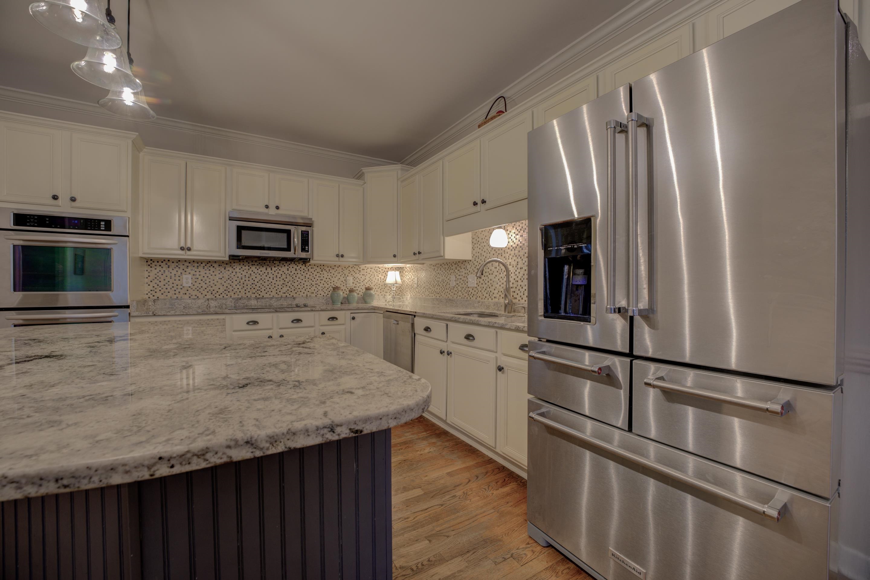9852 Garden Place Collierville, TN 38139 - Photo 12 of 38 a kitchen with kitchen island a counter top space stainless steel appliances and cabinets