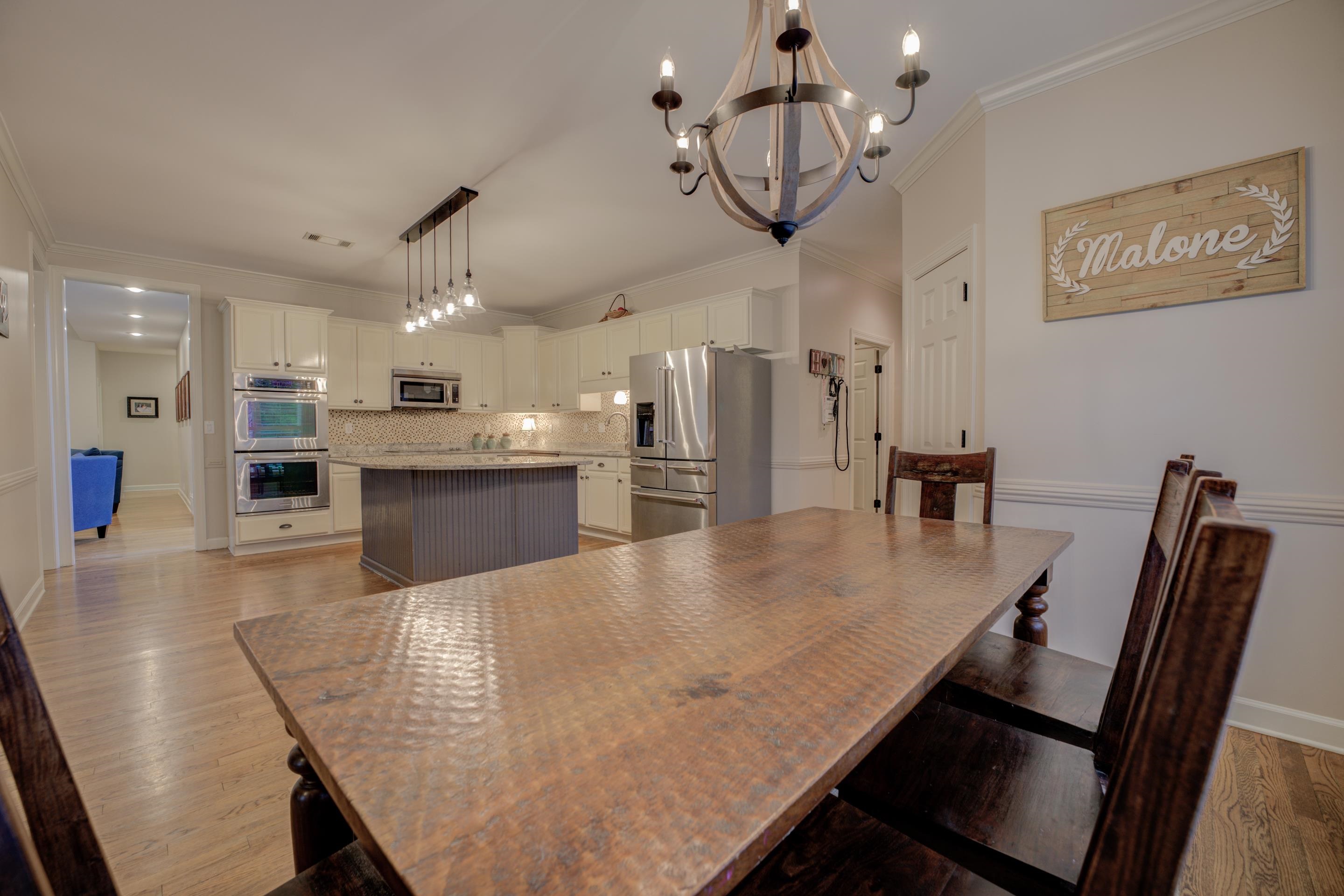 9852 Garden Place Collierville, TN 38139 - Photo 14 of 38 a large kitchen with dining table and stainless steel appliances
