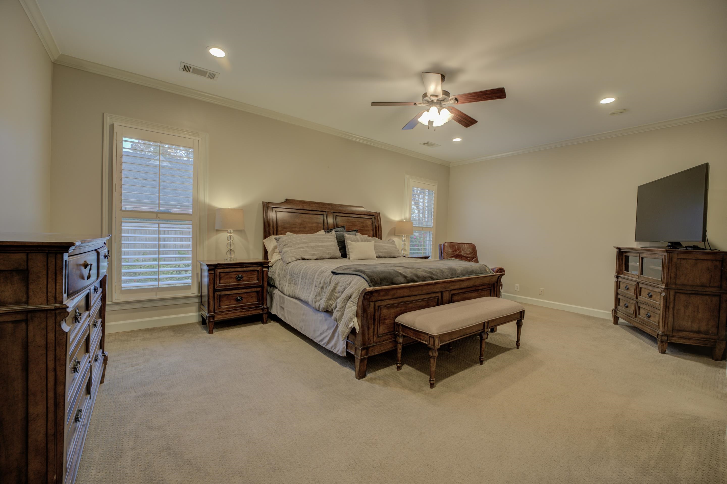 9852 Garden Place Collierville, TN 38139 - Photo 17 of 38 a bedroom with a bed and a chandelier