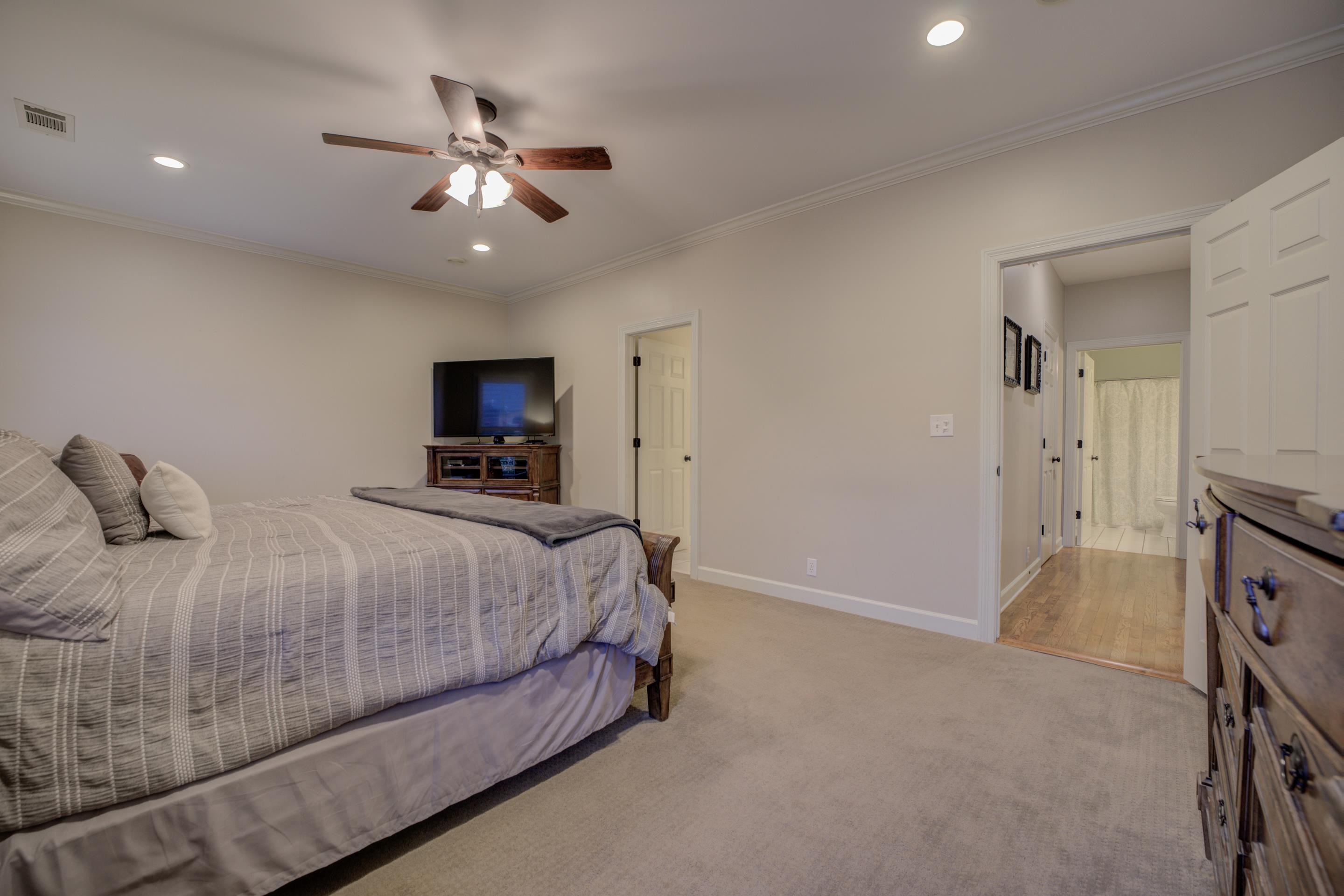 9852 Garden Place Collierville, TN 38139 - Photo 21 of 38 a bedroom with a bed and a ceiling fan