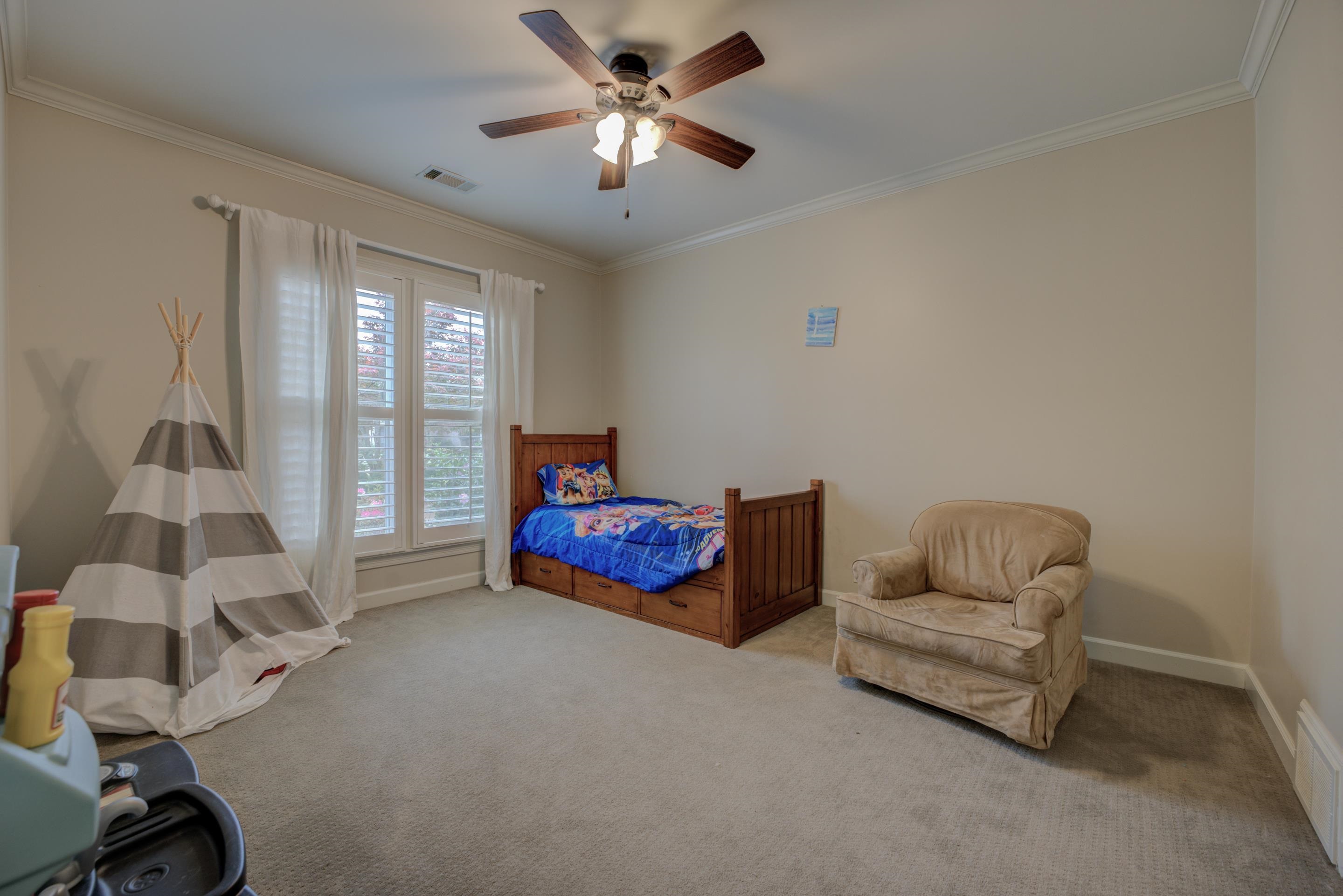 9852 Garden Place Collierville, TN 38139 - Photo 22 of 38 a bedroom with furniture and a ceiling fan