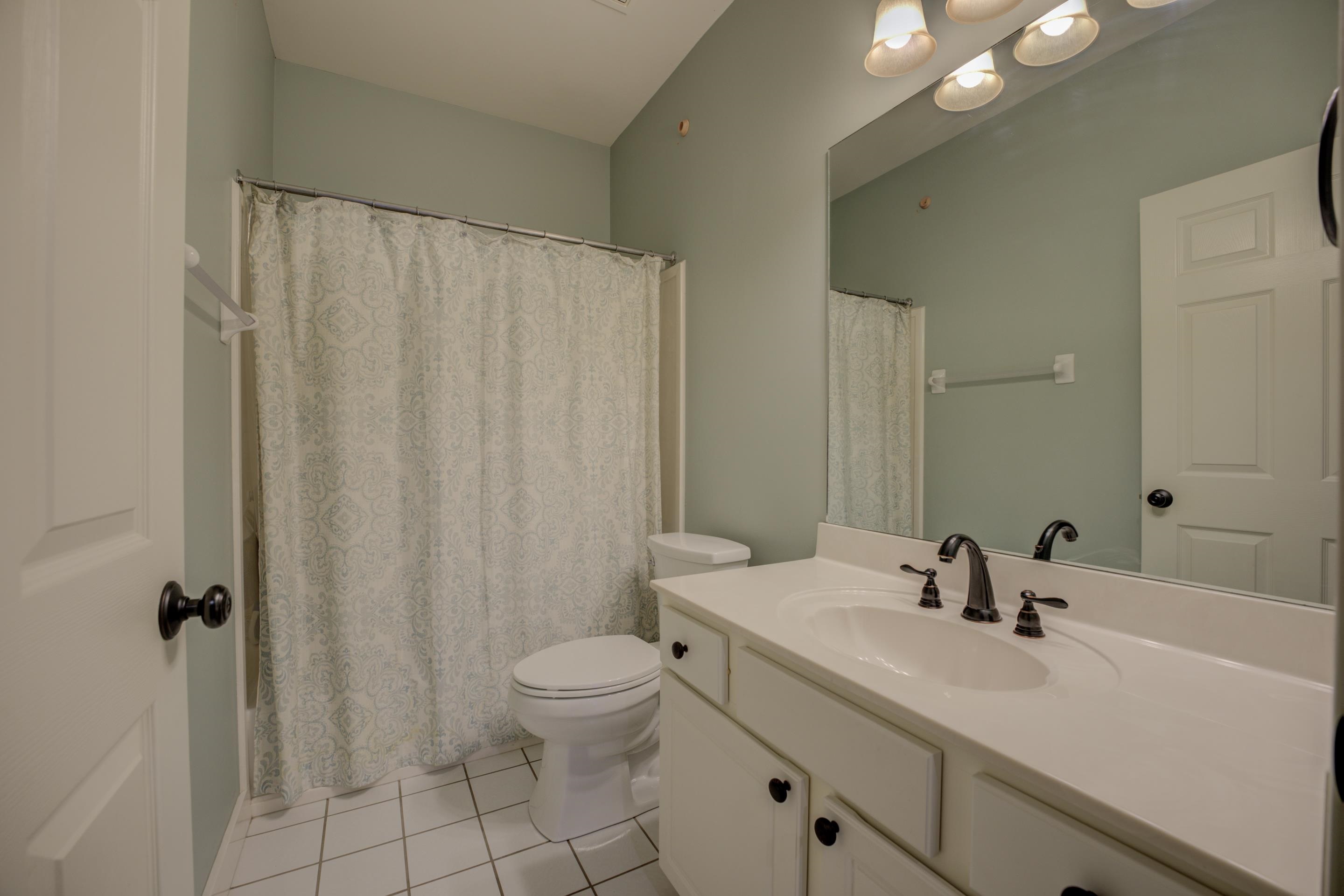 9852 Garden Place Collierville, TN 38139 - Photo 23 of 38 a bathroom with a sink a toilet and shower curtain