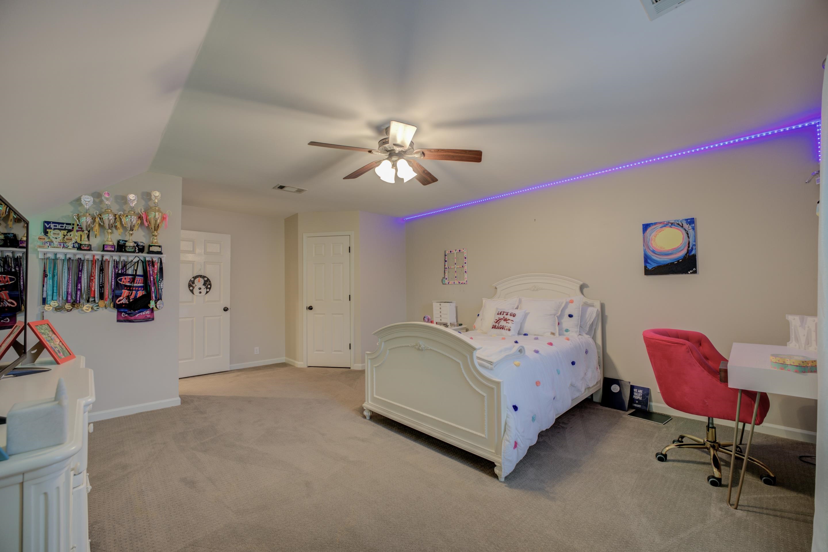 9852 Garden Place Collierville, TN 38139 - Photo 27 of 38 a spacious bedroom with a bed and a chandelier