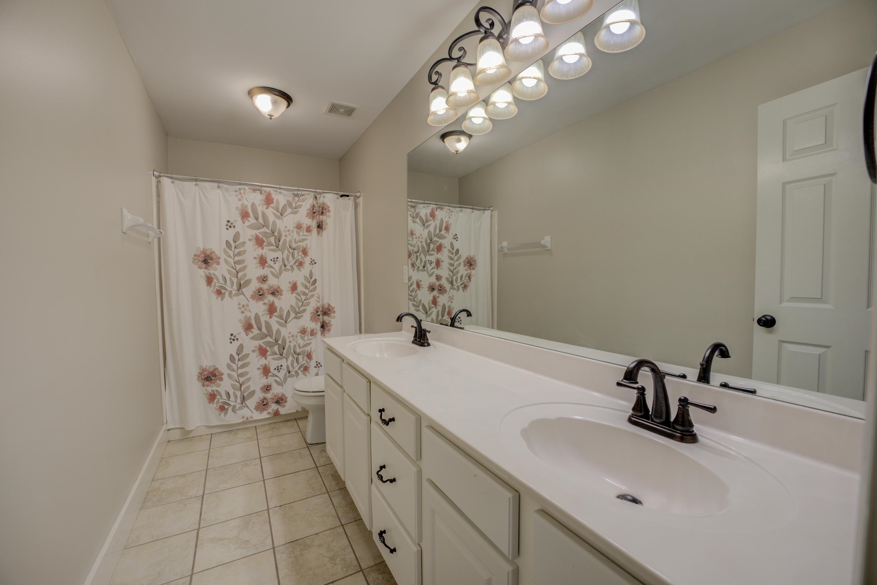 9852 Garden Place Collierville, TN 38139 - Photo 28 of 38 a bathroom with a sink a toilet and shower