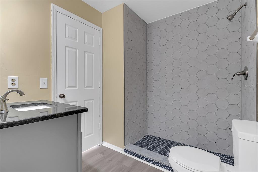 36 Springwood Square Port Orange, FL 32129 - Photo 20 of 31 a bathroom with a granite countertop toilet and sink