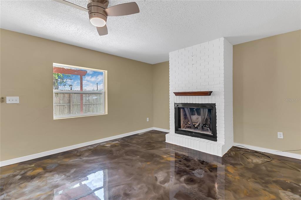 36 Springwood Square Port Orange, FL 32129 - Photo 3 of 31 a view of an empty room with a fireplace and a window