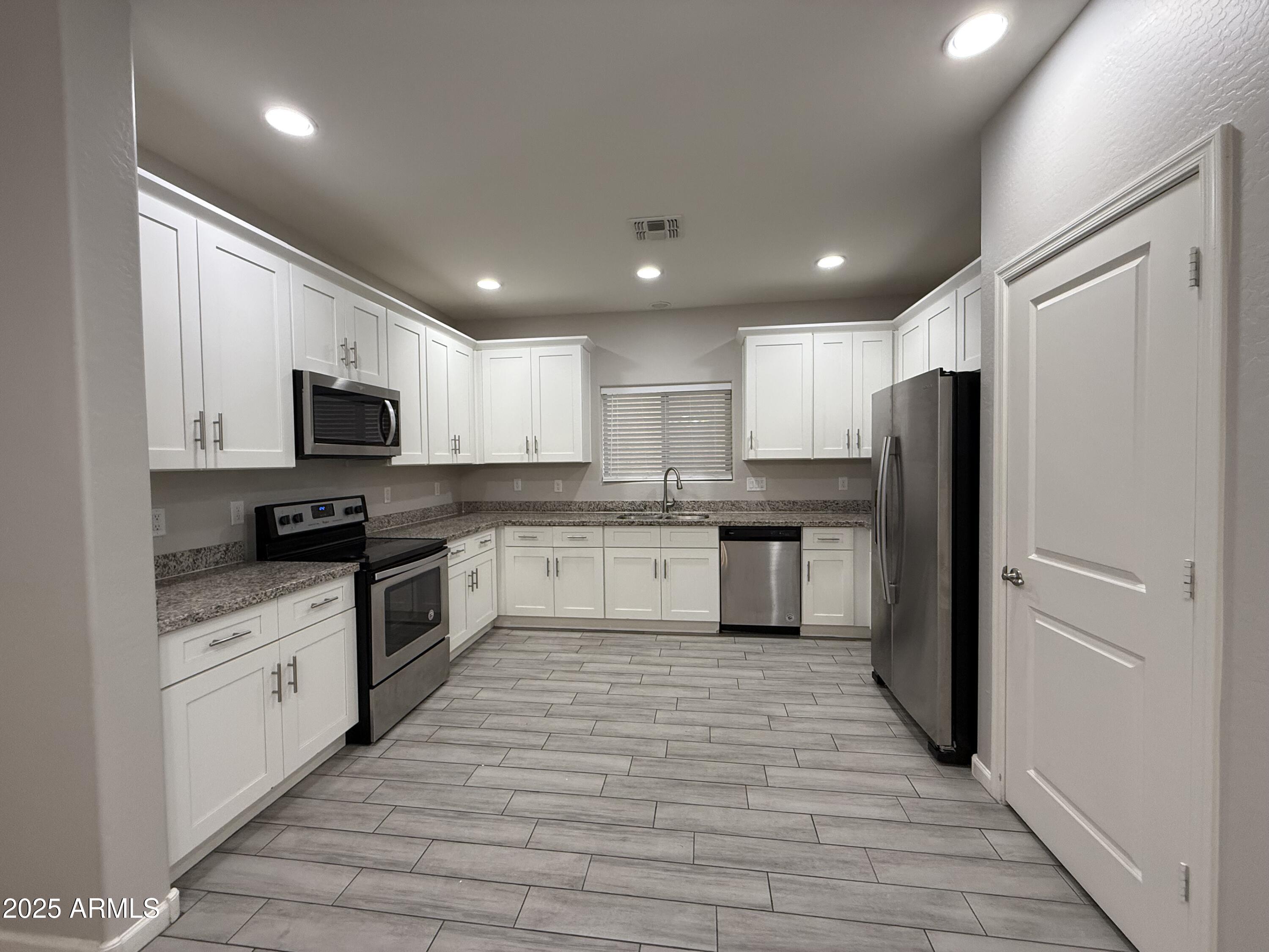 1743 West Pollack Street Phoenix, AZ 85041 - Photo 14 of 46 a large kitchen with stainless steel appliances lots of counter top space and cabinets