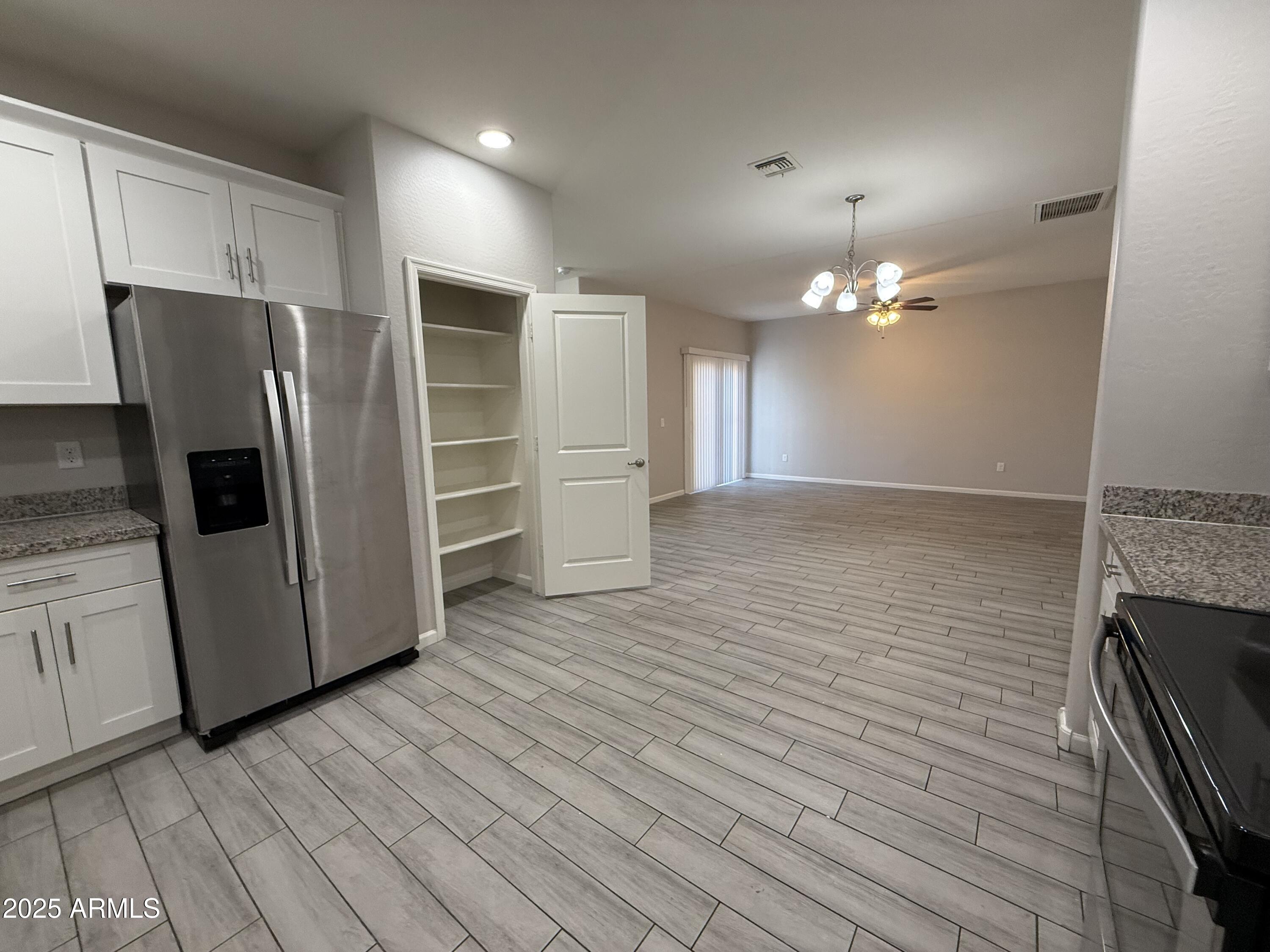 1743 West Pollack Street Phoenix, AZ 85041 - Photo 15 of 46 a view of a kitchen with wooden floor and electronic appliances