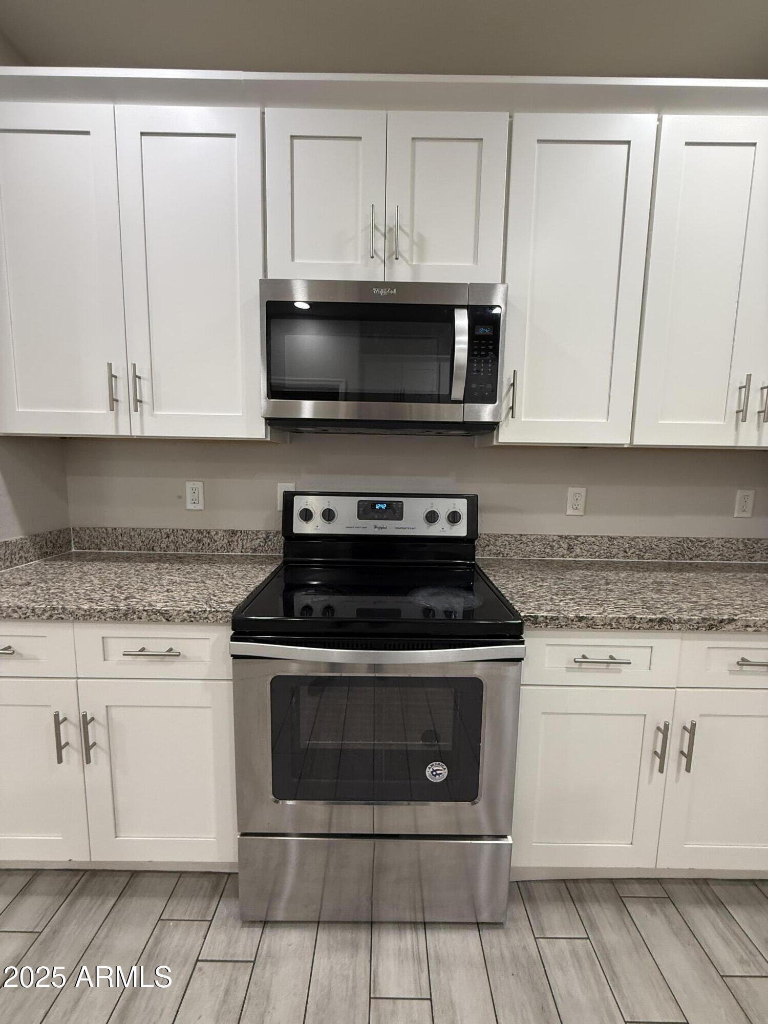 1743 West Pollack Street Phoenix, AZ 85041 - Photo 16 of 46 a stove top oven sitting inside of a kitchen