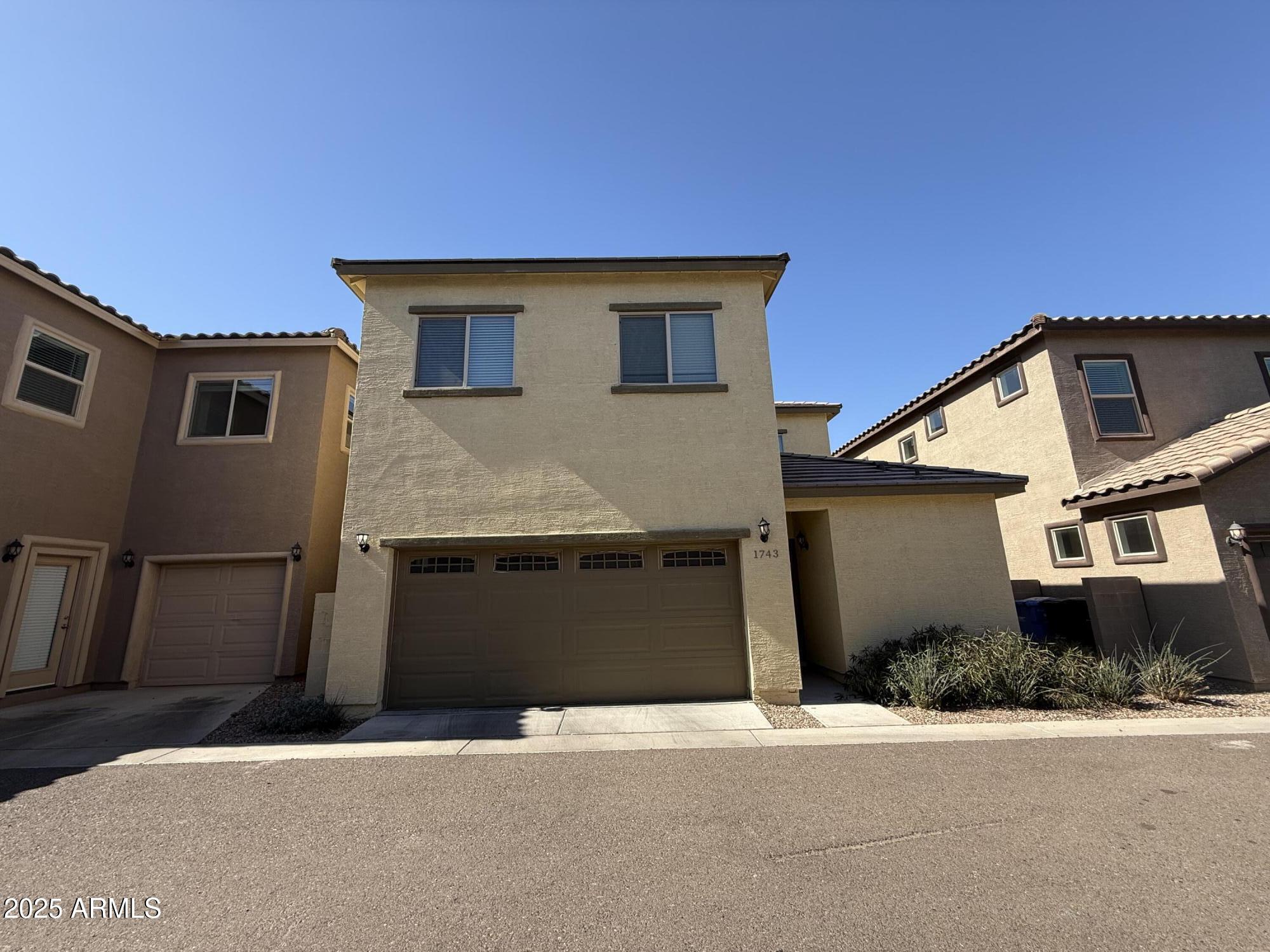 1743 West Pollack Street Phoenix, AZ 85041 - Photo 2 of 46 a front view of a house with garage