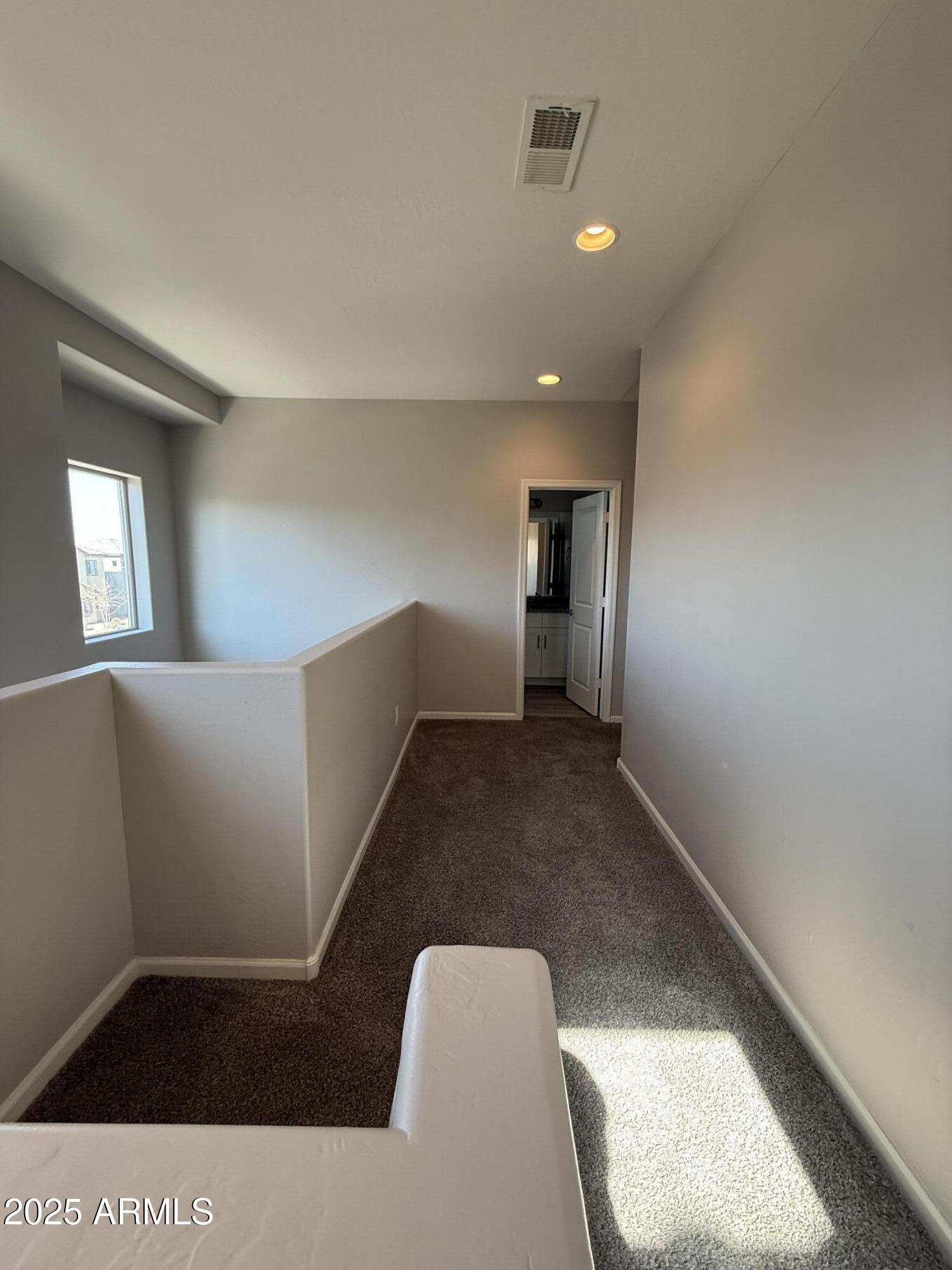 1743 West Pollack Street Phoenix, AZ 85041 - Photo 29 of 46 a view of an empty room with wooden floor and a window