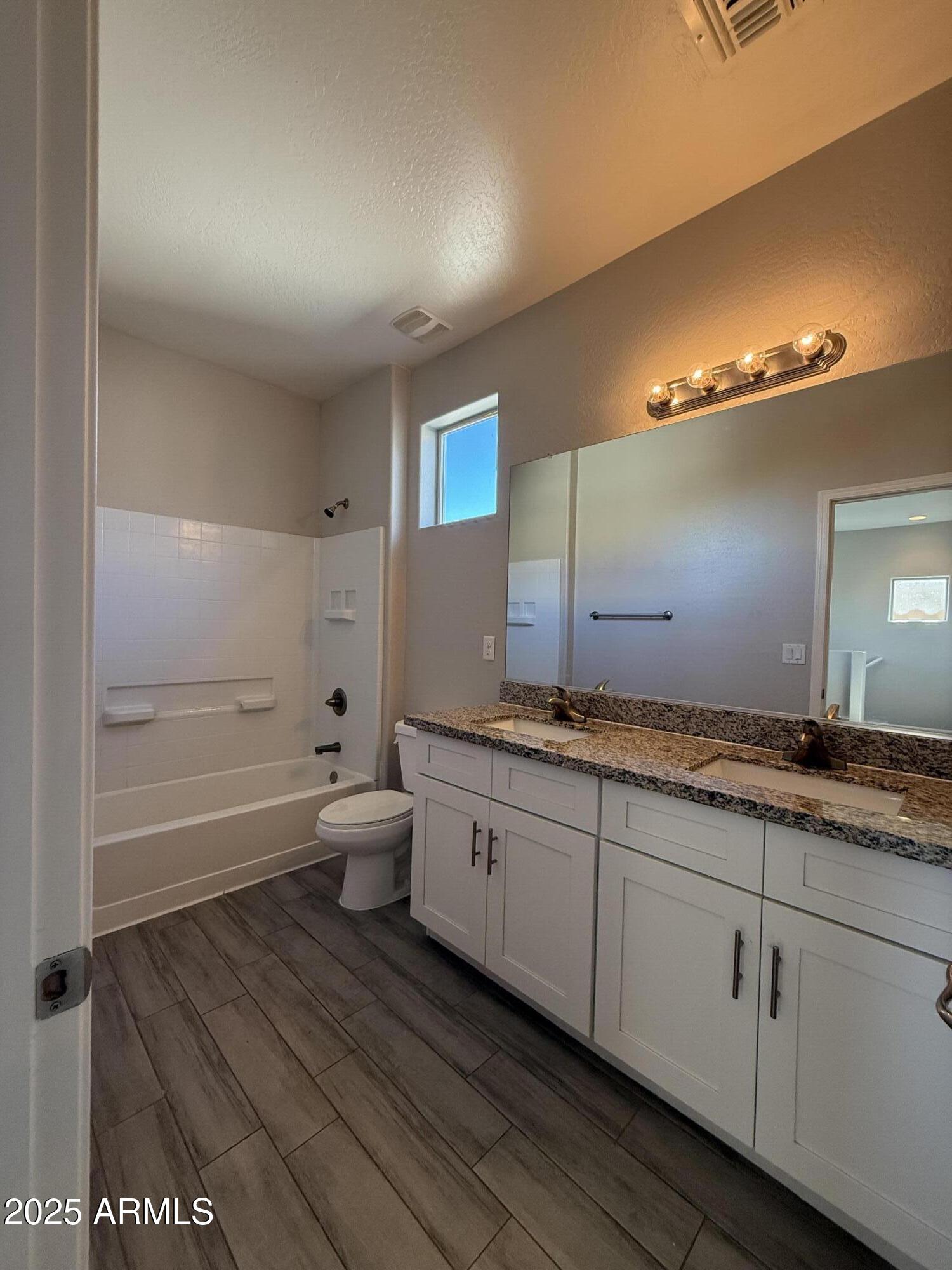 1743 West Pollack Street Phoenix, AZ 85041 - Photo 30 of 46 a bathroom with a granite countertop sink mirror vanity and toilet
