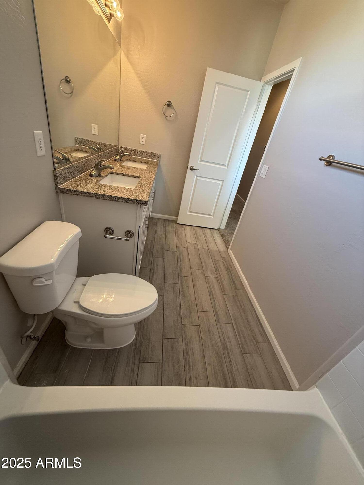 1743 West Pollack Street Phoenix, AZ 85041 - Photo 31 of 46 a bathroom with a toilet a sink and a mirror