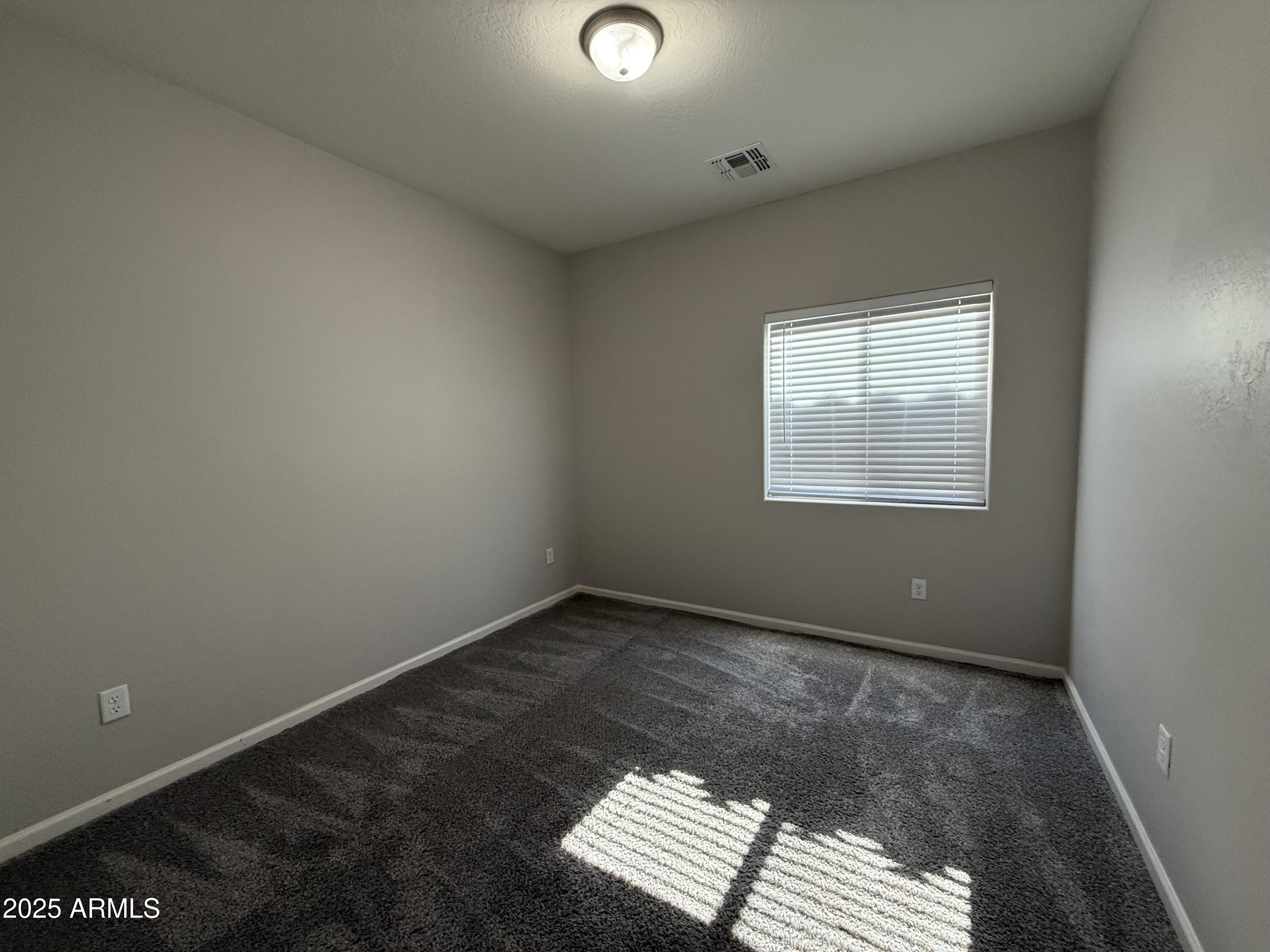 1743 West Pollack Street Phoenix, AZ 85041 - Photo 32 of 46 an empty room with a window