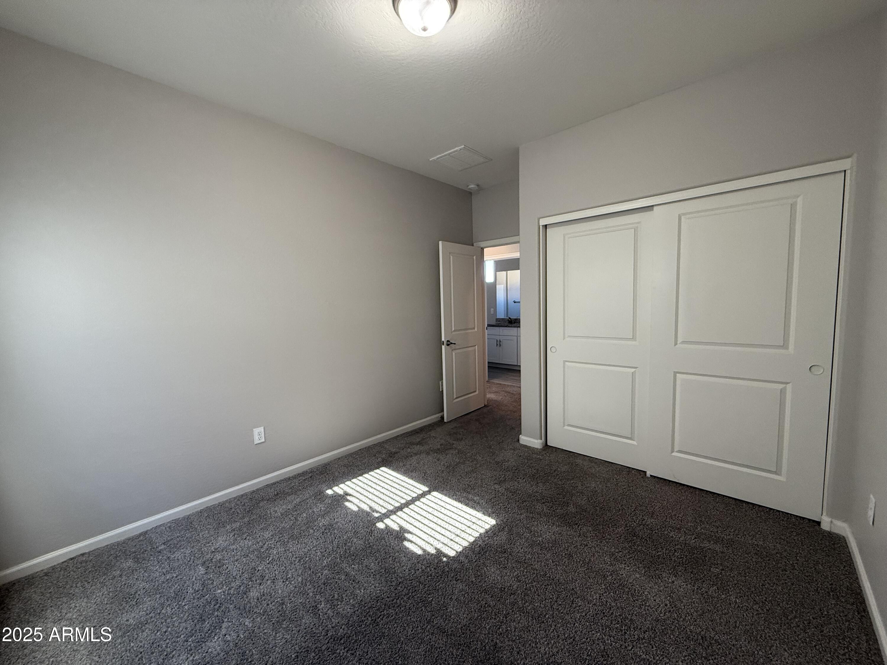 1743 West Pollack Street Phoenix, AZ 85041 - Photo 33 of 46 an empty room with windows