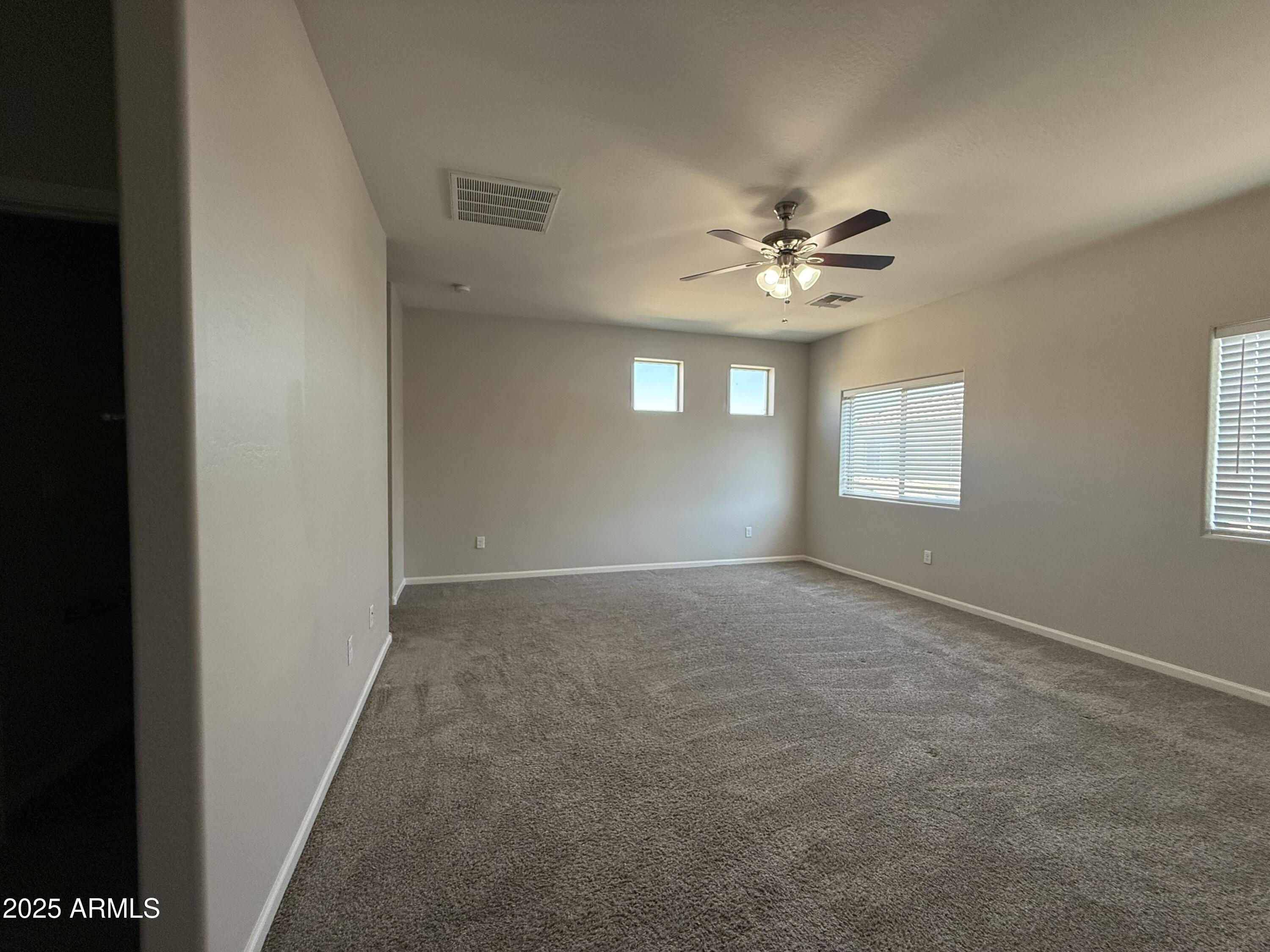1743 West Pollack Street Phoenix, AZ 85041 - Photo 34 of 46 an empty room with windows and fan