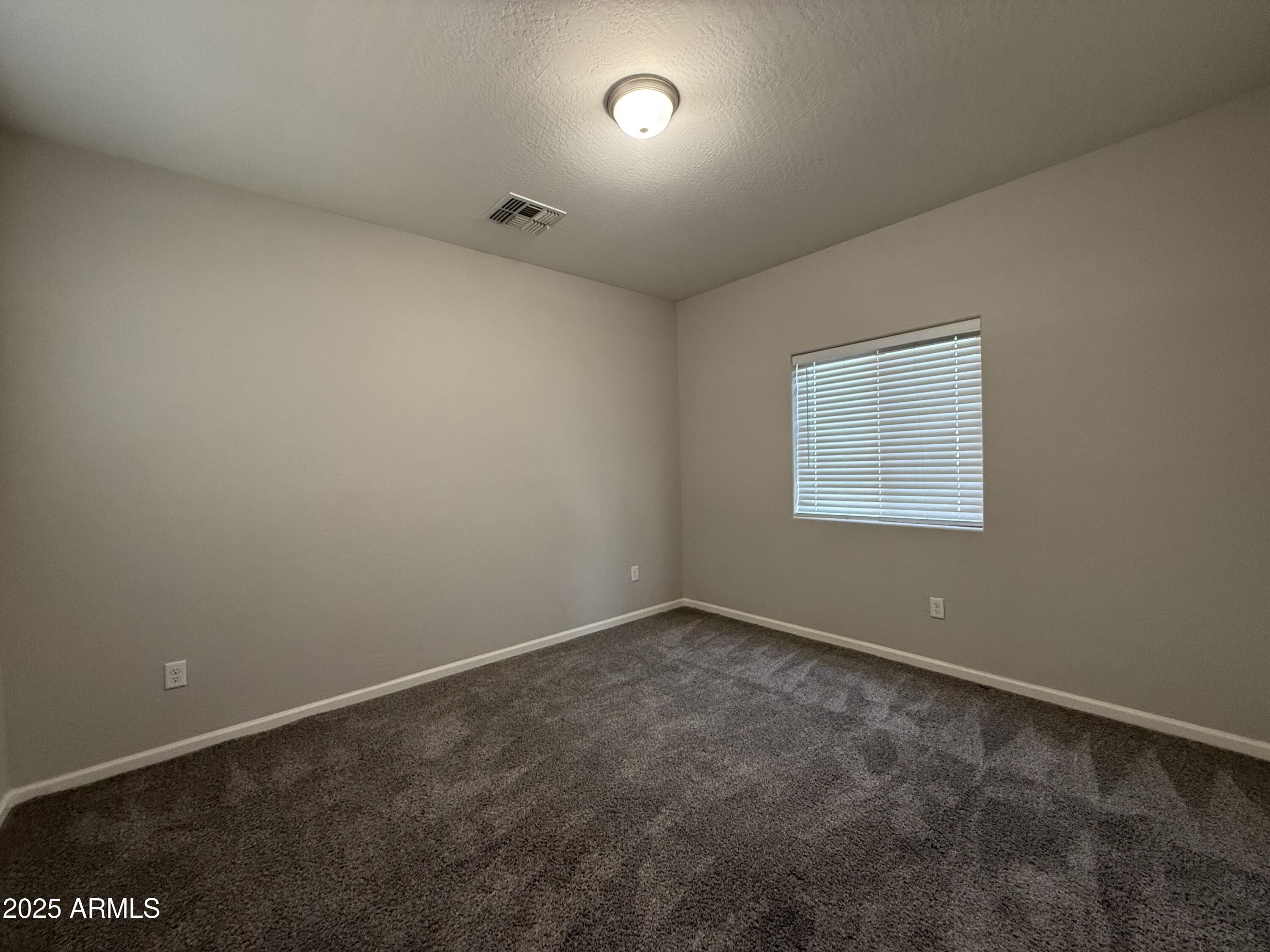 1743 West Pollack Street Phoenix, AZ 85041 - Photo 35 of 46 an empty room with a empty space and windows