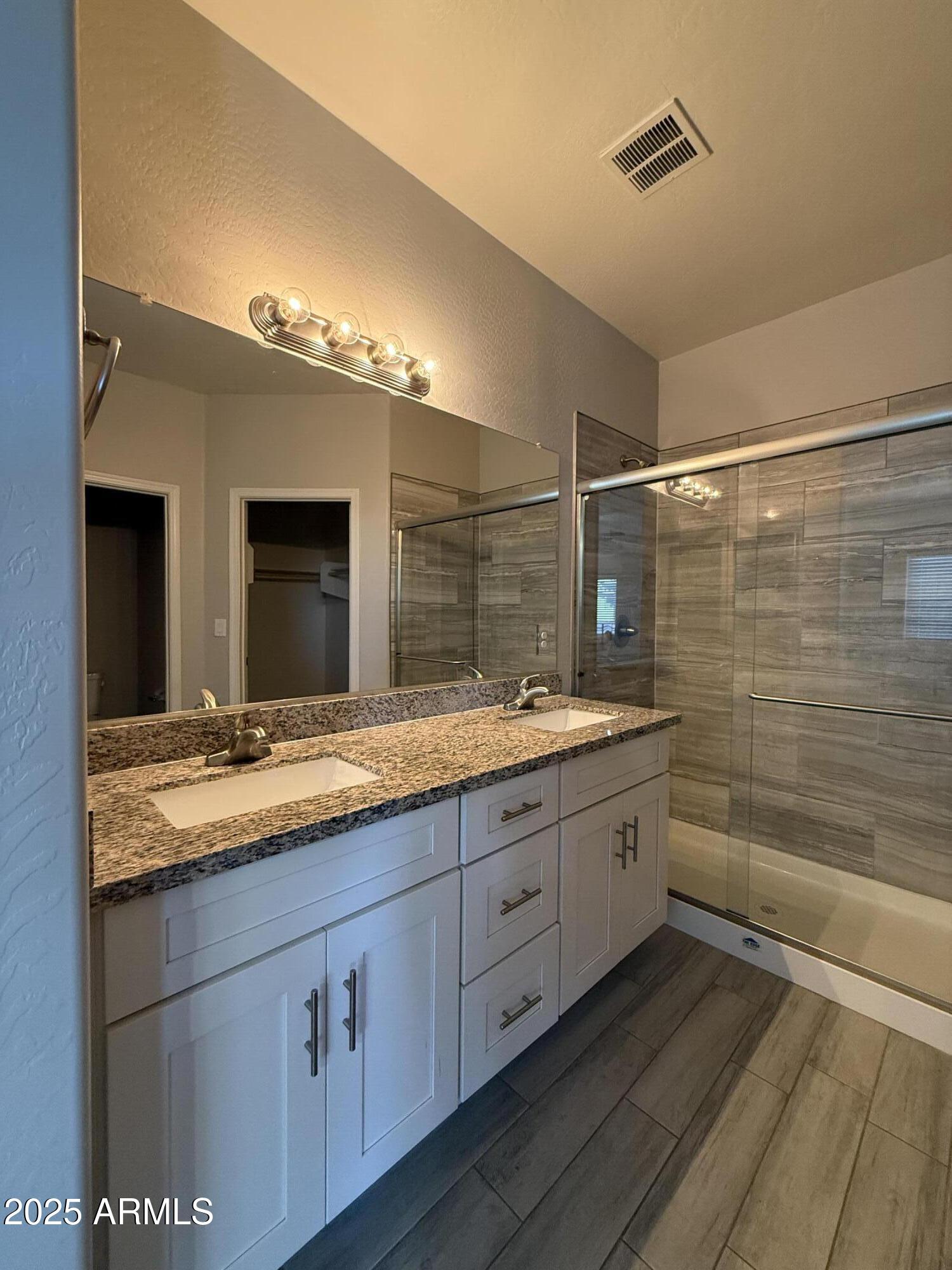 1743 West Pollack Street Phoenix, AZ 85041 - Photo 41 of 46 a bathroom with a granite countertop sink mirror and shower