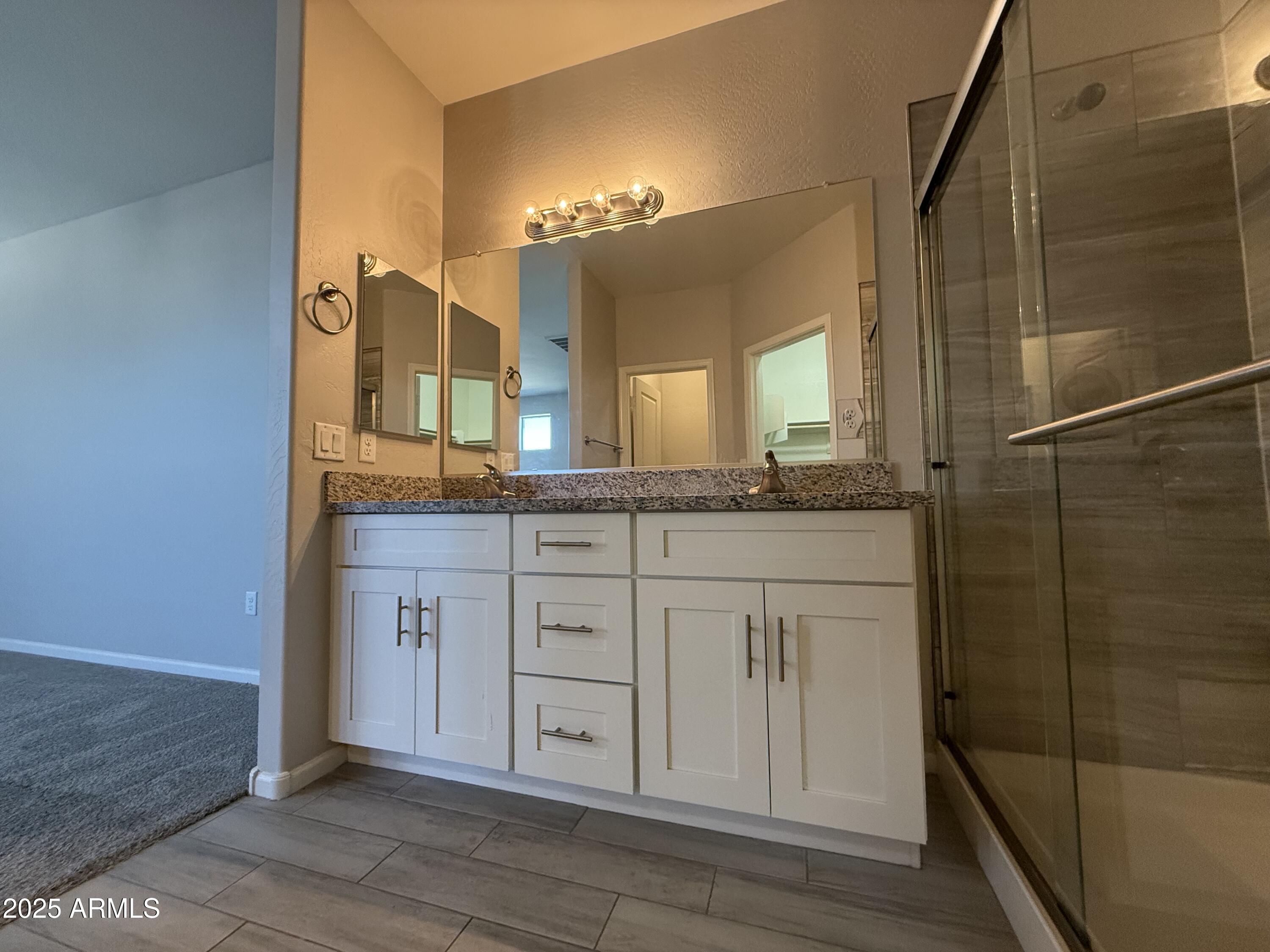 1743 West Pollack Street Phoenix, AZ 85041 - Photo 46 of 46 a bathroom with a granite countertop sink and a mirror