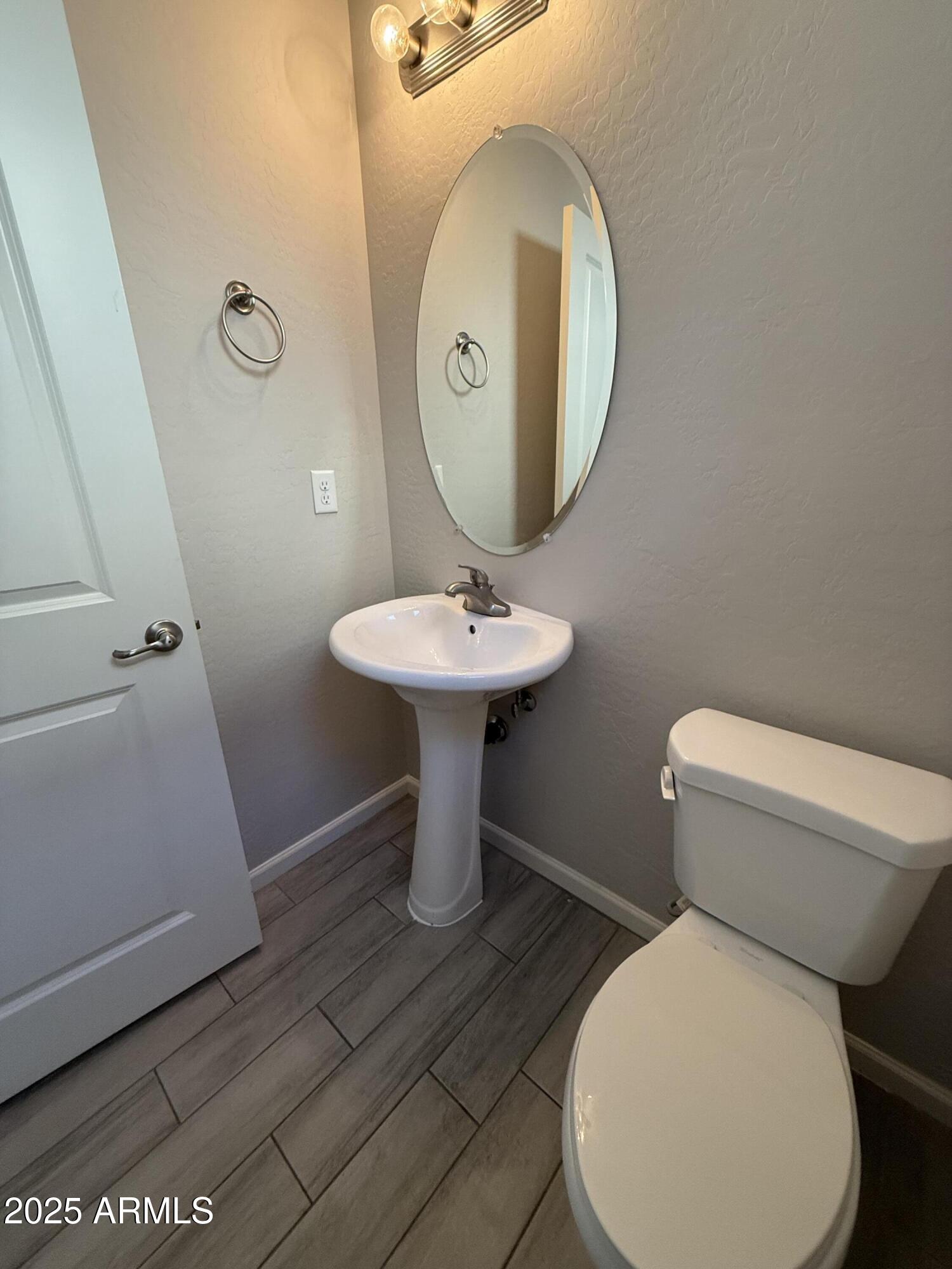 1743 West Pollack Street Phoenix, AZ 85041 - Photo 6 of 46 a bathroom with a toilet sink and mirror