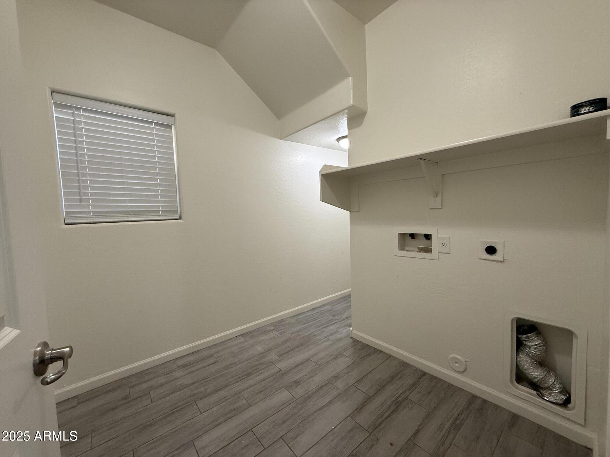1743 West Pollack Street Phoenix, AZ 85041 - Photo 8 of 46 an empty room with a workbench