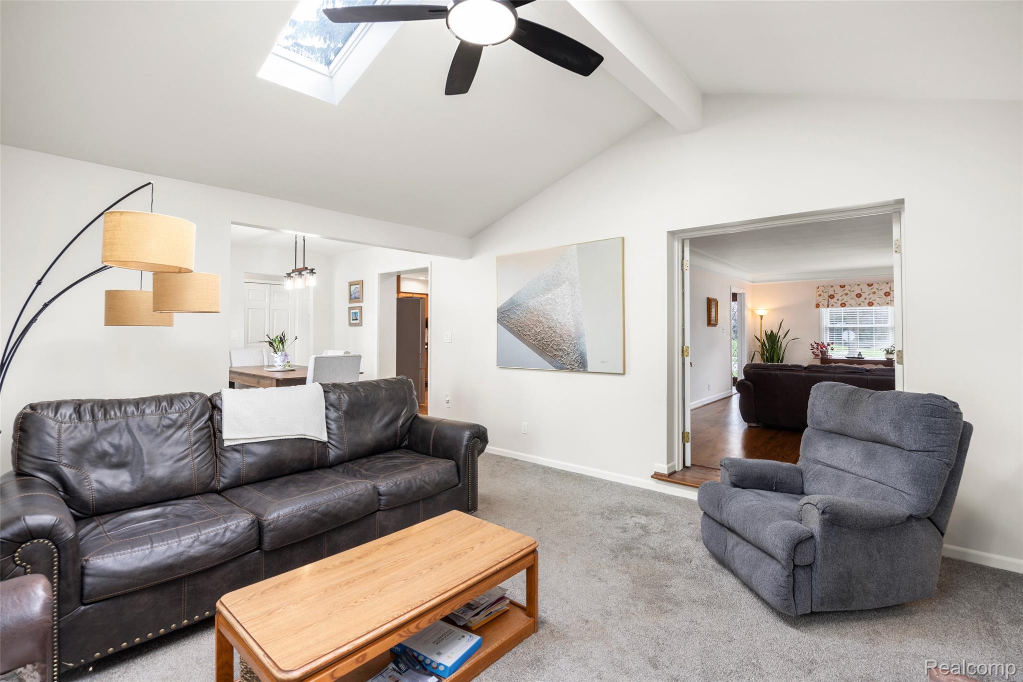 244 Kerby Road Grosse Pointe, MI 48236 - Photo 13 of 53 Carpeted living room with a ceiling fan and a skylight