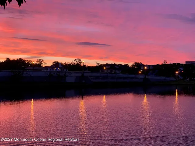 a view of a room with a window and wooden floor