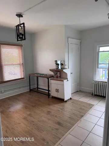 a kitchen with a refrigerator a stove top oven and cabinets