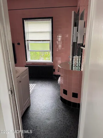 a living room with a bed furniture and a window