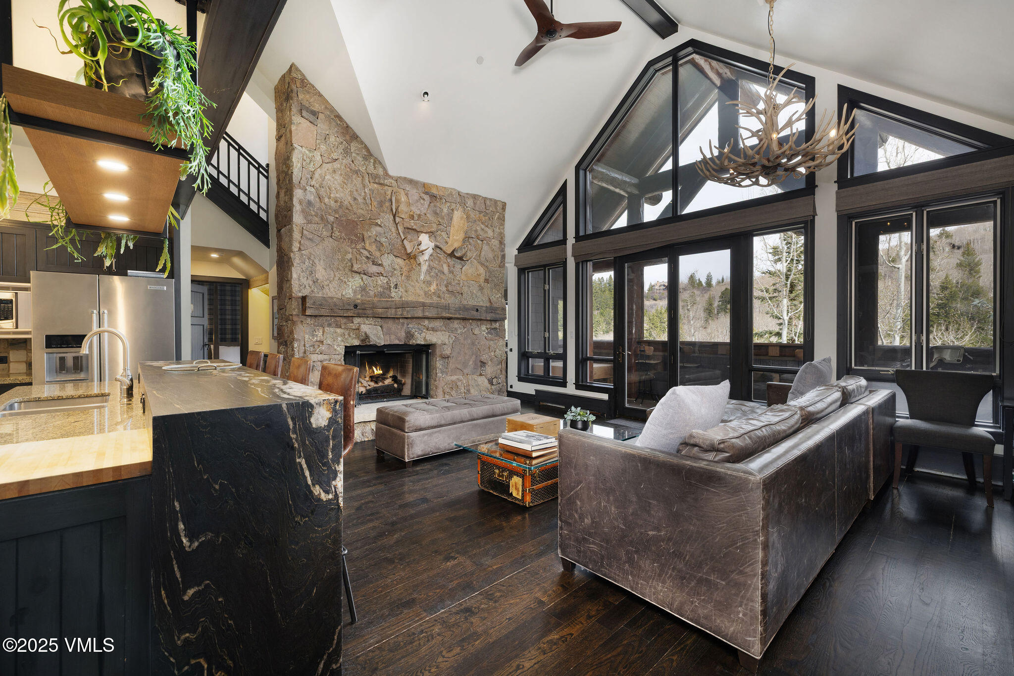 180 Daybreak Ridge Road, Unit 711 Beaver Creek, CO 81620 - Photo 1 of 17 a living room with furniture fireplace and a large window